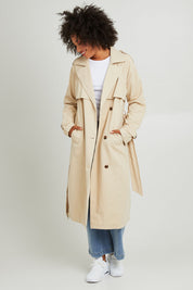Model Olivia wearing size 10 of the Eve Trench Coat in colour Tan, from the front, showing the whole outfit