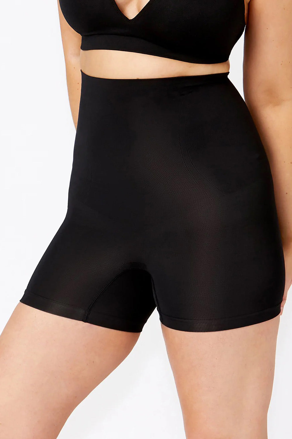 A model wearing the Powerlite High Waisted Short in colour Black, from the front, cropped image