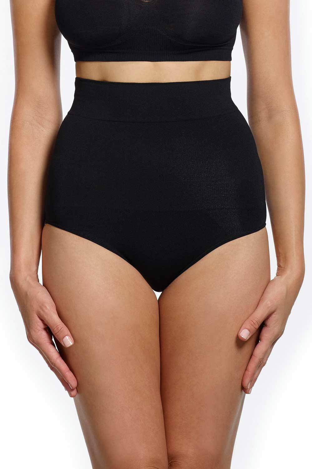 A model wearing the Killer Figure Ab Shaper Brief in colour Black (Black), from the front, cropped image