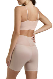A model wearing the Micro Grip Short in colour Rosebeige, from the back