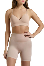 A model wearing the Micro Grip Short in colour Rosebeige, from the front, cropped image