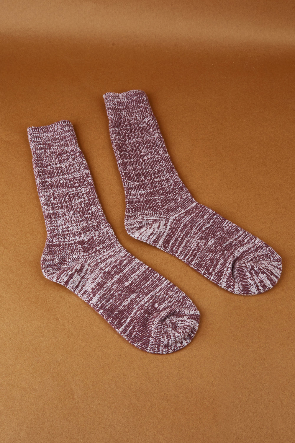 A model wearing size OneSize of the Recycled Polyester Slouch Sock in colour Sangria (Purple), from the front, showing the whole outfit