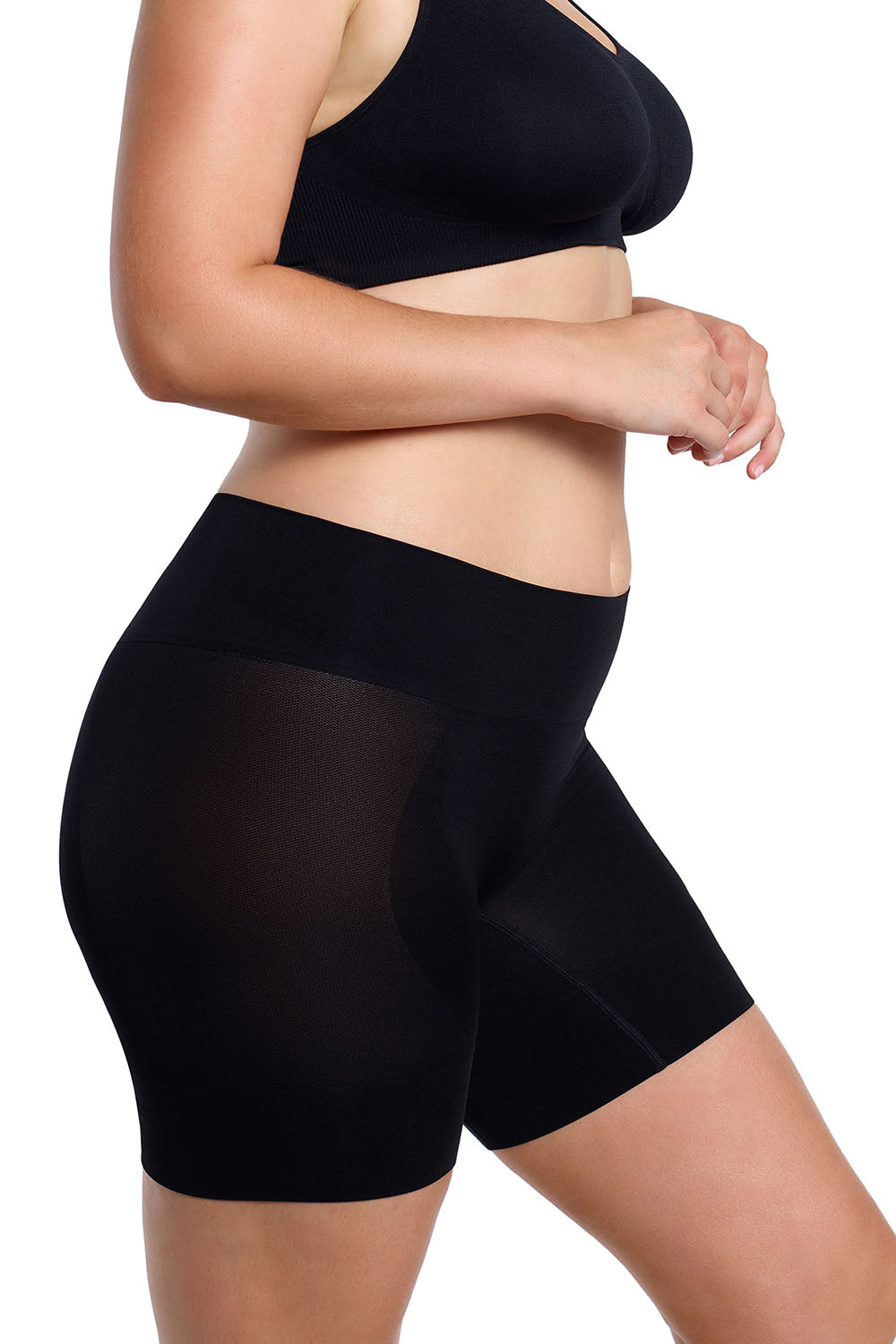A model wearing the Curvesque Antiin colourChafing Short - Black (Black), from the back