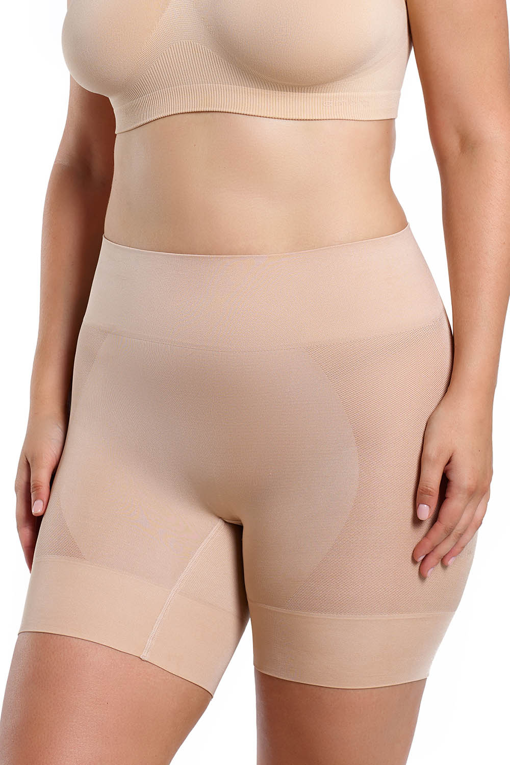 A model wearing the Curvesque Antiin colourChafing Short - Nude, from the front, cropped image