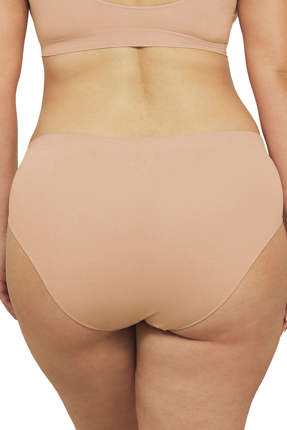 A model wearing the Bare Essentials Hi Cut Brief in colour Rosebeige, from the back