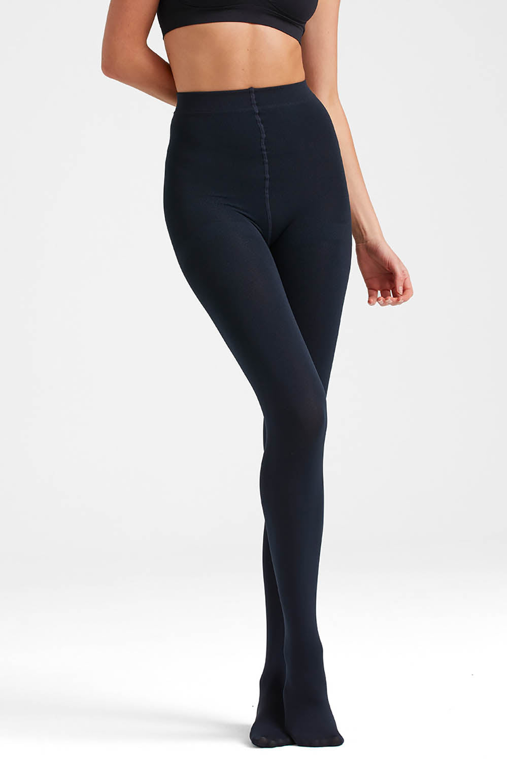 A model wearing the Velvet Fleece Tights in colour Navy (Blue), from the front, cropped image