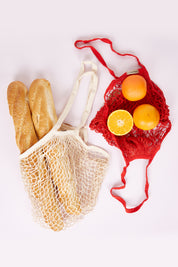 A model wearing size OneSize of the Shopping String Bag in colour Red (Red), from the front, showing the whole outfit