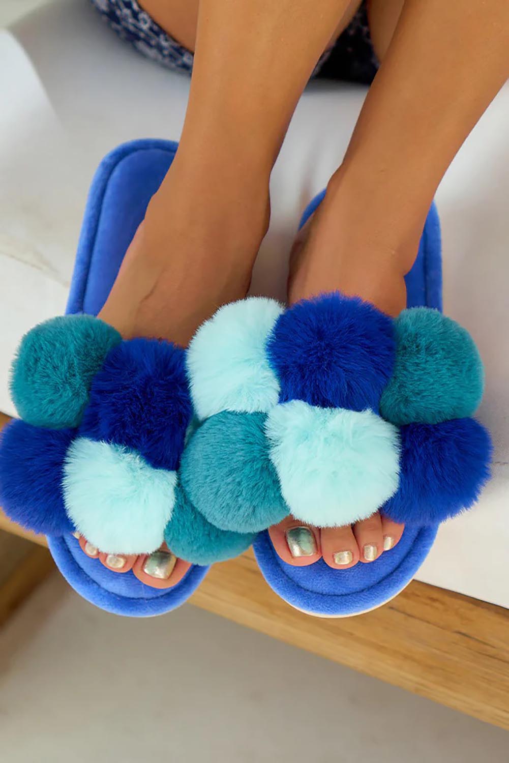 A model wearing the Pom Pom Slipper in colour Bluemulti (Blue), from the front, showing the whole outfit