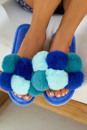 A model wearing the Pom Pom Slipper in colour Bluemulti (Blue), from the front, showing the whole outfit