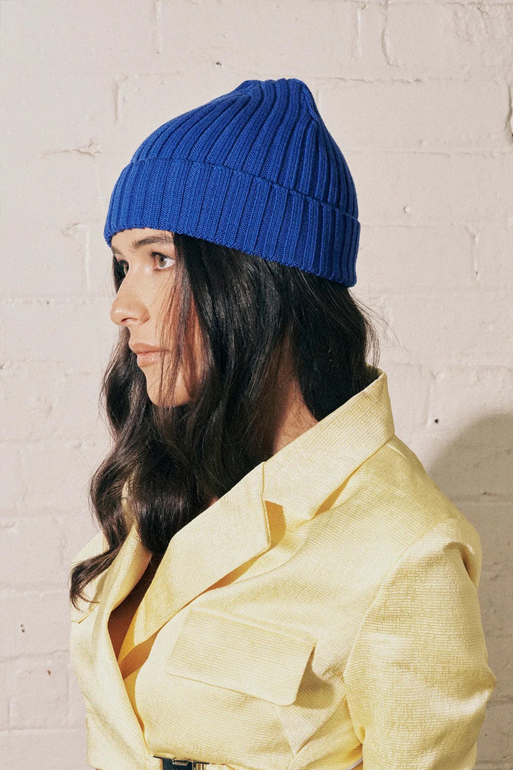 A model wearing the Tucker Merino Wool Beanie in colour Royal (Blue), from the front, showing the whole outfit