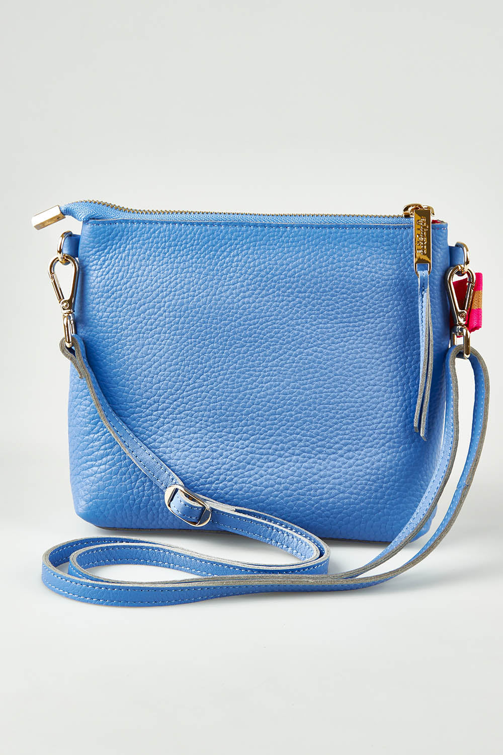 A model wearing size OneSize of the Alexis Leather Crossbody in colour Cornflower (Blue), from the front, showing the whole outfit
