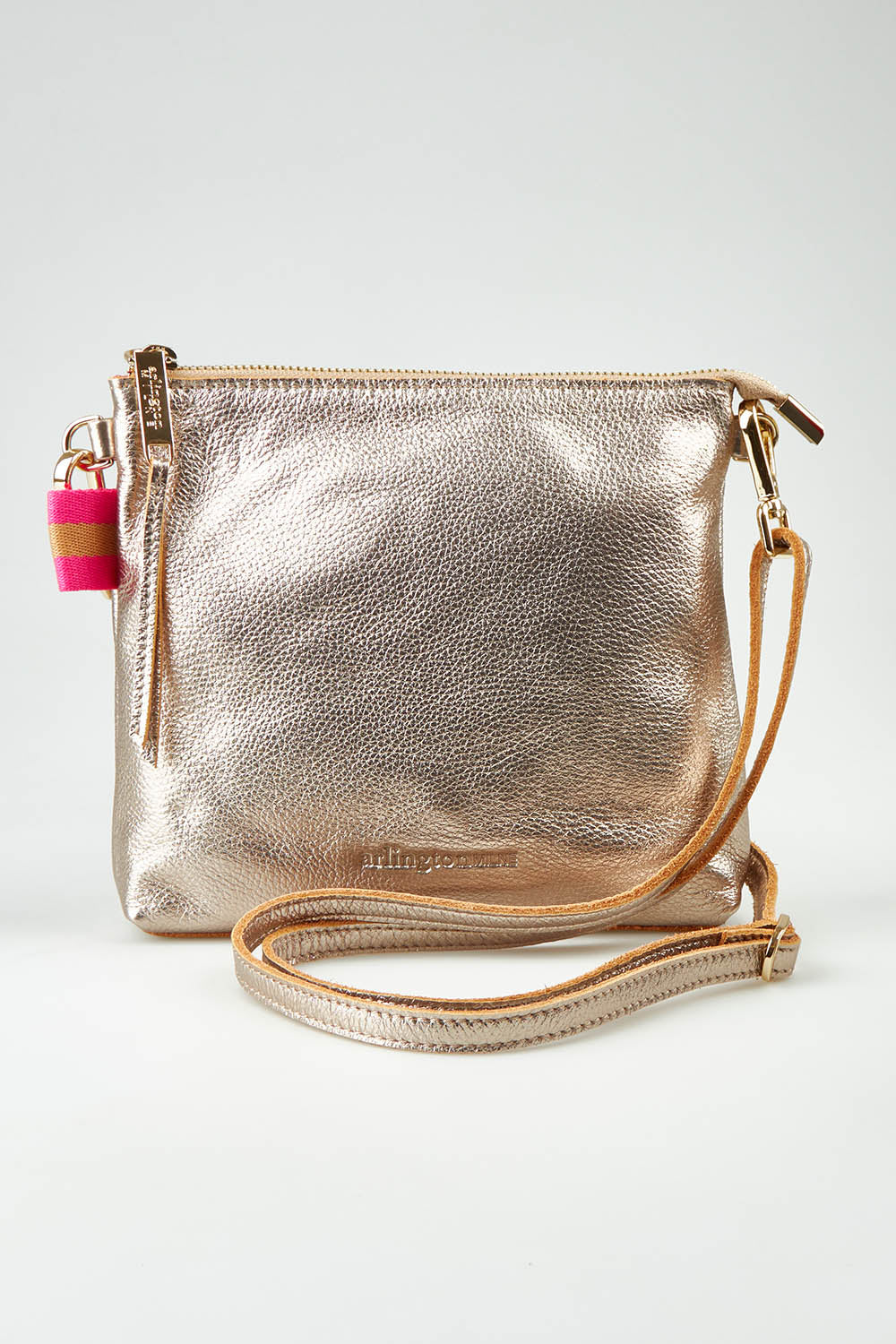 A model wearing size OneSize of the Alexis Leather Crossbody in colour Gold (Metallics), from the front, showing the whole outfit