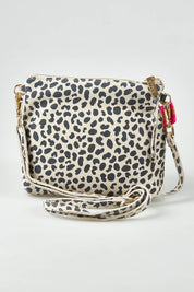 A model wearing size OneSize of the Alexis Leather Crossbody in colour Spotsuede, from the front, showing the whole outfit