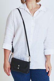 Model Steph wearing size OneSize of the Paige Leather Wallet in colour Black (Black), from the front, cropped image