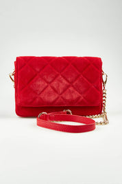 A model wearing the Sarah Leather Quilted Crossbody in colour Redsuede (Red), from the front, showing the whole outfit