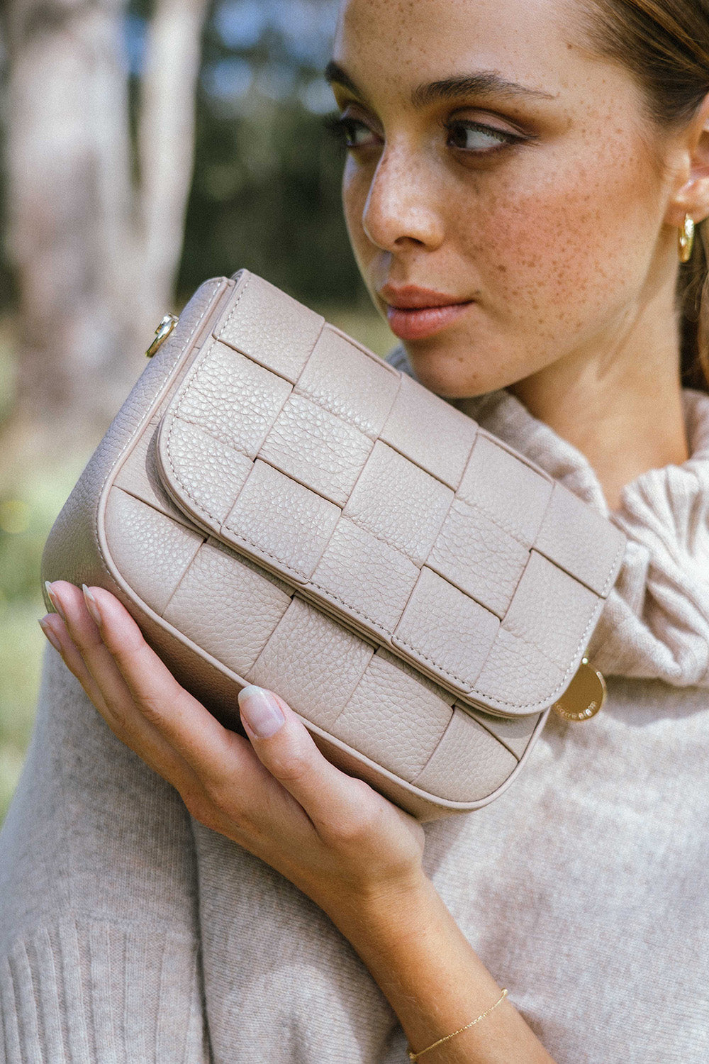 A model wearing the Clara Weave Leather Crossbody in colour Fawn, from the front, showing the whole outfit