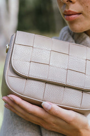 A model wearing the Clara Weave Leather Crossbody in colour Fawn, from the front, showing the whole outfit