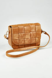 A model wearing size OneSize of the Clara Weave Leather Crossbody in colour Vinagetan, from the front, showing the whole outfit