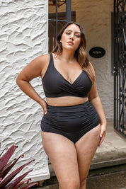 A model wearing the Raphael High Waist Ruched Swim Pant in colour Black (Black), from the front, showing the whole outfit