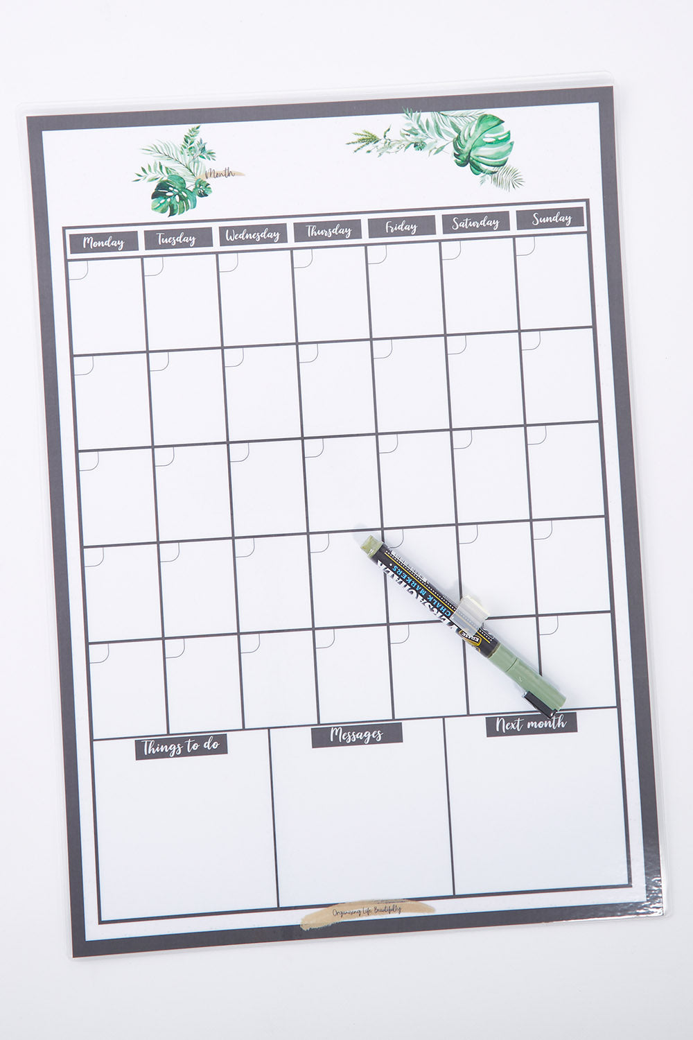 A model wearing size OneSize of the Reusable A3 Monthly Wall Calendar And Pen Set in colour Greenery (Green), from the front, showing the whole outfit