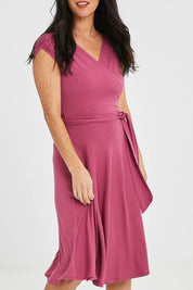 Model Katie wearing size S of the Wrap Dress in colour Dryrose (Pink), from the front, cropped image