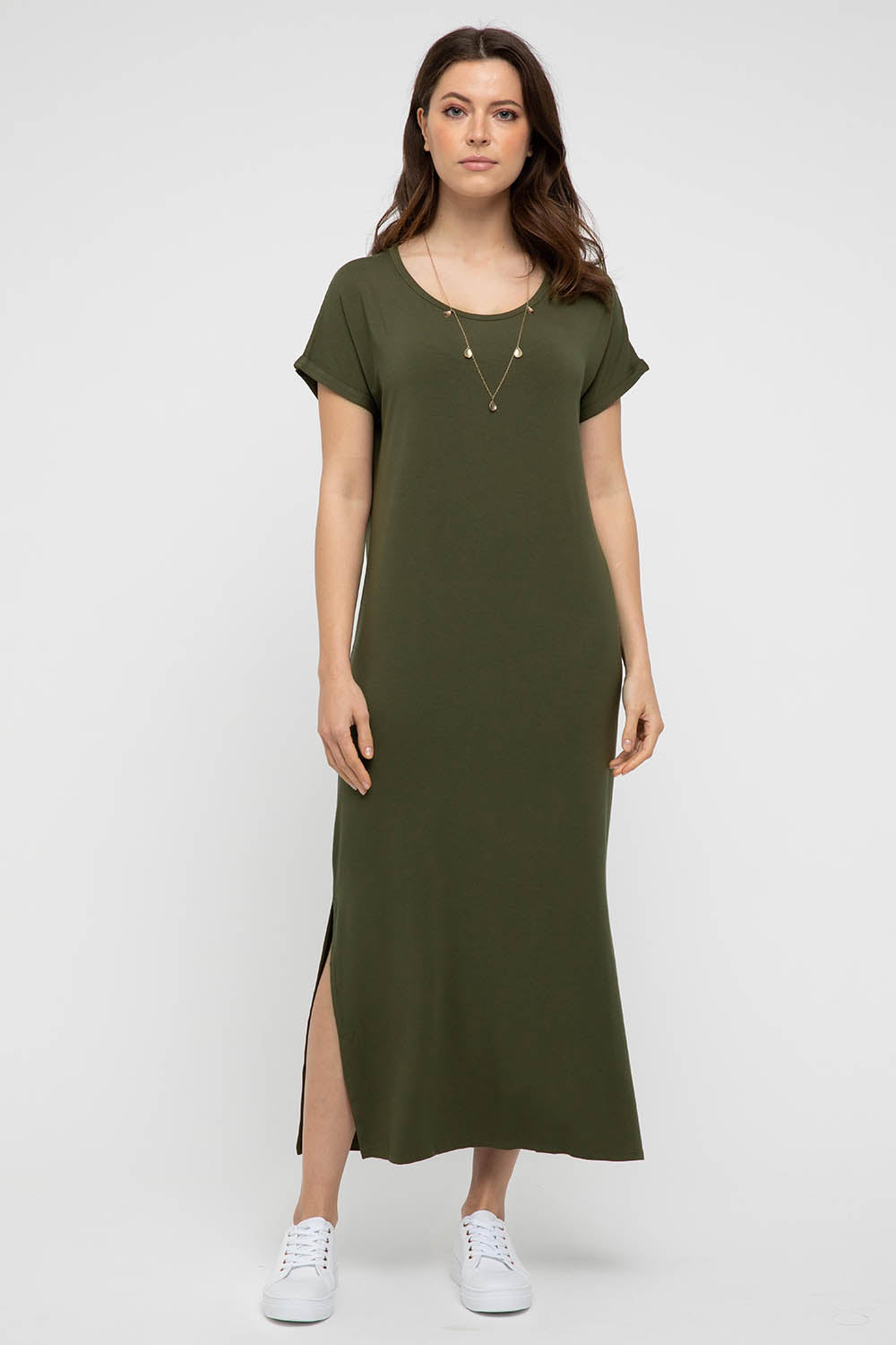 A model wearing the Elsie Dress in colour Darkolive (Green), from the front, showing the whole outfit