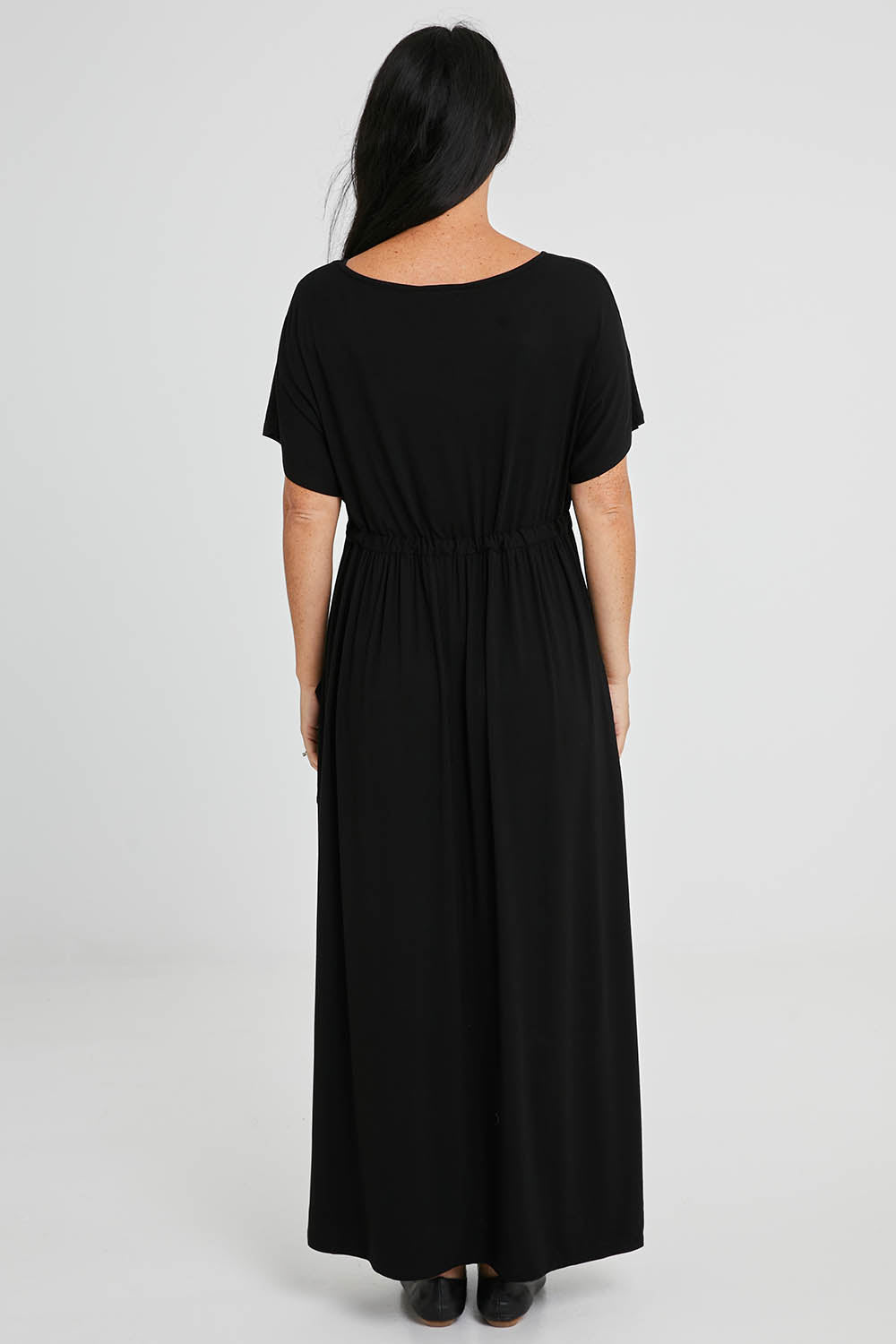 Model Katie wearing size S of the Mila Maxi Dress in colour Black (Black), from the back