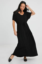 Model Katie wearing size S of the Mila Maxi Dress in colour Black (Black), from the front, showing the whole outfit