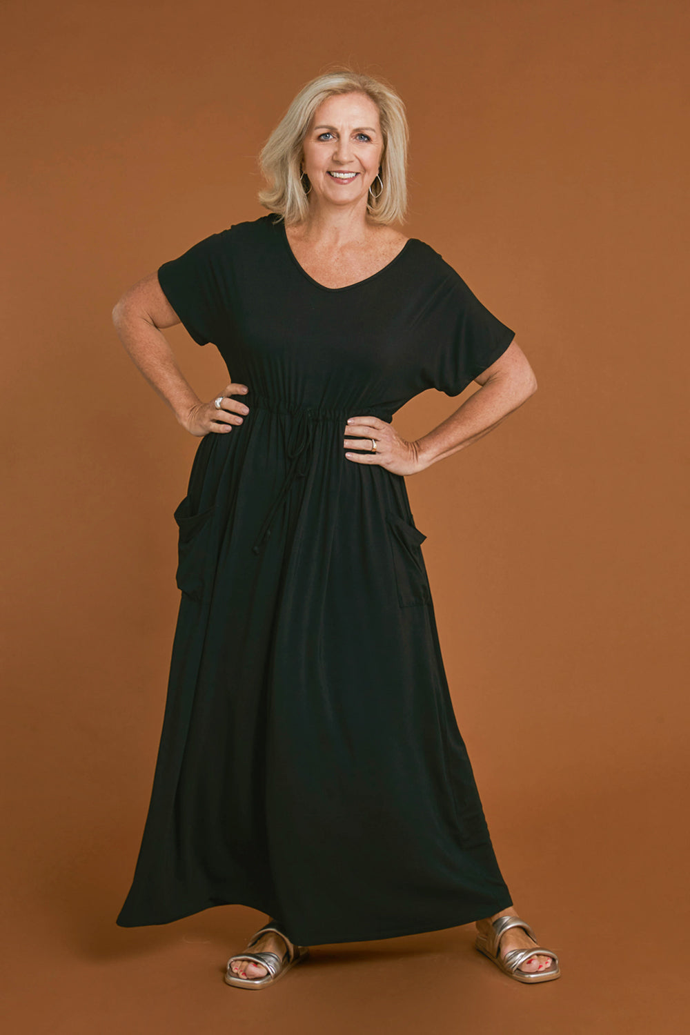 Model Sandy wearing size S of the Mila Maxi Dress in colour Black (Black), from the front, showing the whole outfit