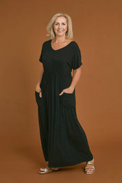 Model Sandy wearing size S of the Mila Maxi Dress in colour Black (Black), from the front, showing the whole outfit