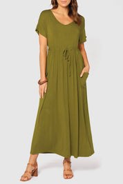 A model wearing the Mila Maxi Dress in colour Cardamom (Green), from the front, cropped image