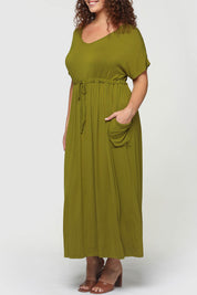A model wearing the Mila Maxi Dress in colour Cardamom (Green), from the front, cropped image