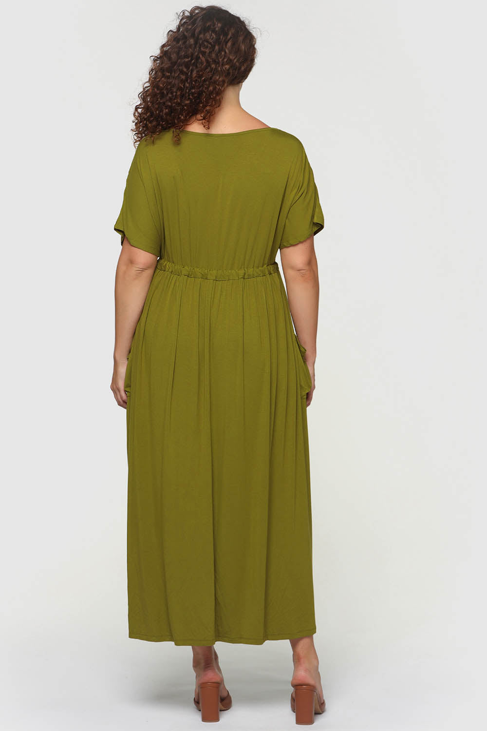 A model wearing the Mila Maxi Dress in colour Cardamom (Green), from the front, cropped image