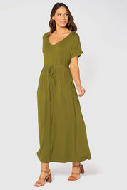 A model wearing the Mila Maxi Dress in colour Cardamom (Green), from the front, showing the whole outfit