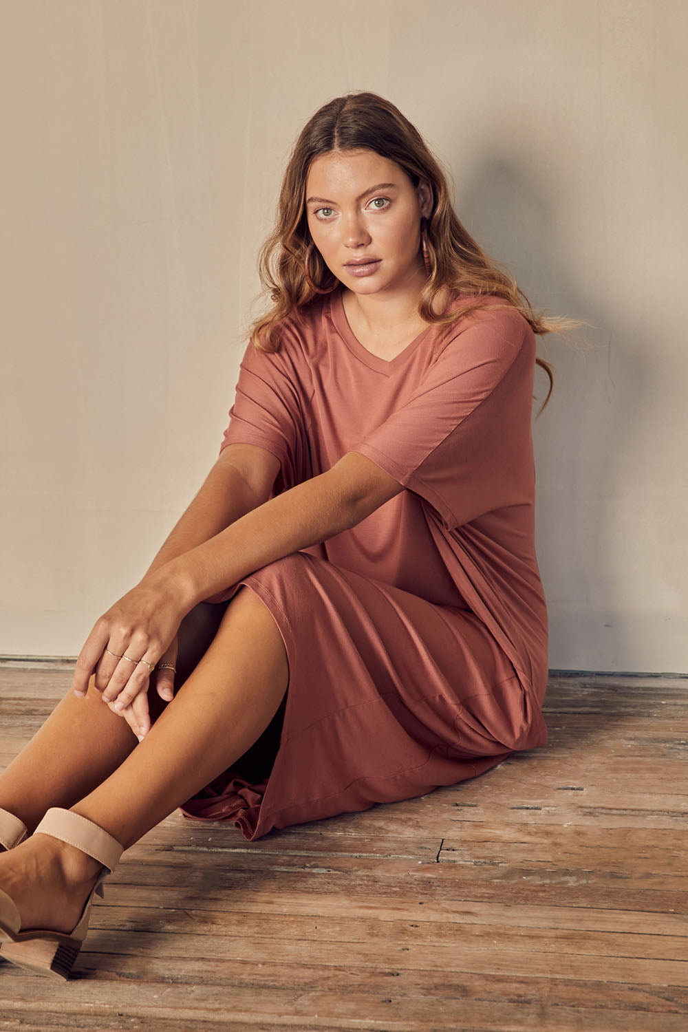 A model wearing the Samara Dress in colour Cedarwood, from the front, showing the whole outfit