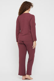 A model wearing the Relax PJ Long Bamboo Pants in colour Burgundy (Red), from the back