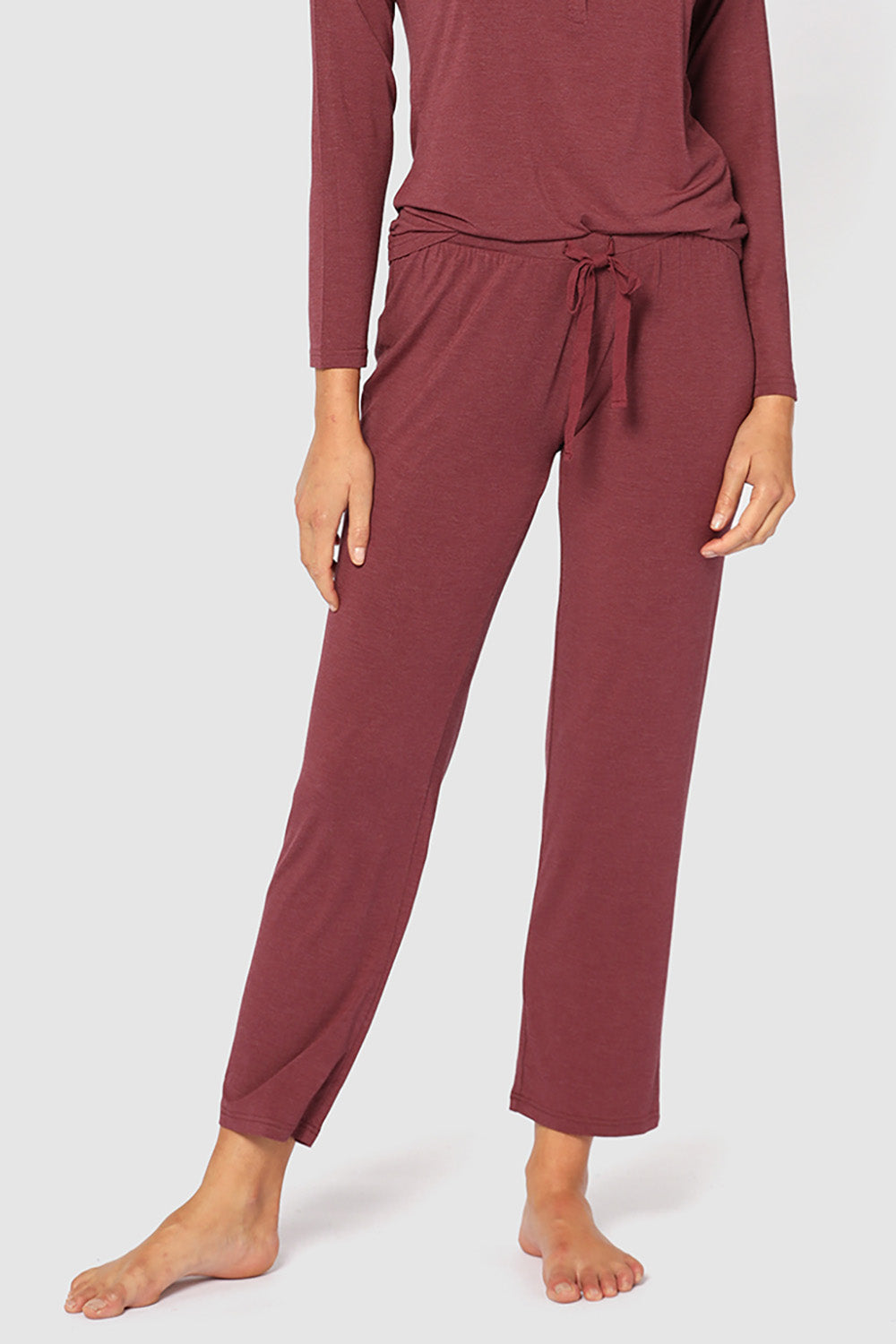 A model wearing the Relax PJ Long Bamboo Pants in colour Burgundy (Red), from the front, cropped image