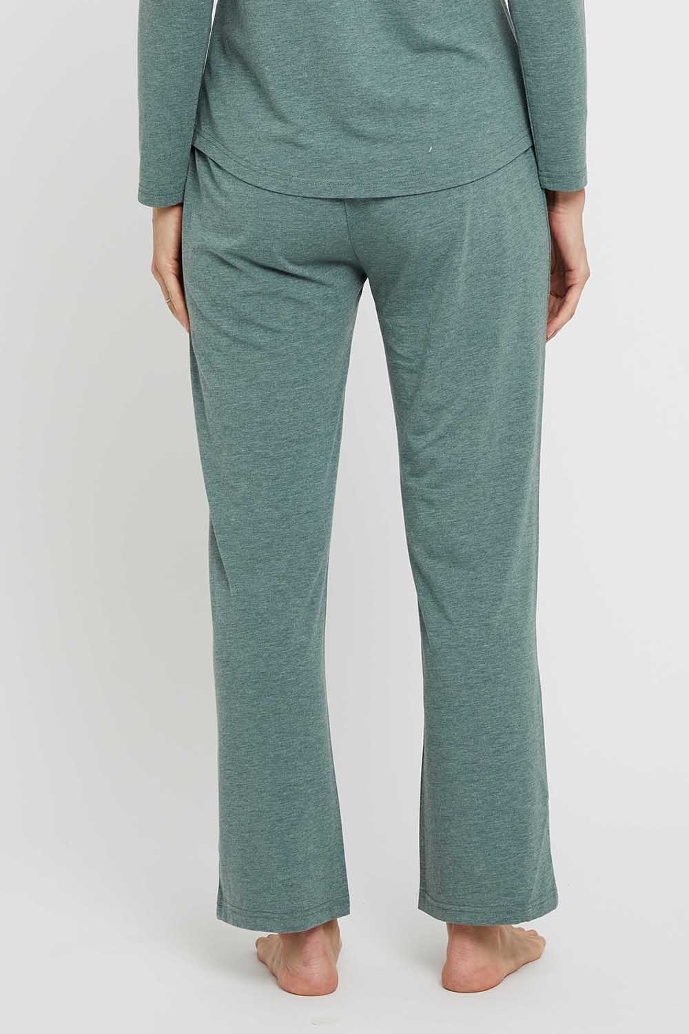 A model wearing the Relax PJ Long Bamboo Pants in colour Moss (Green), from the back