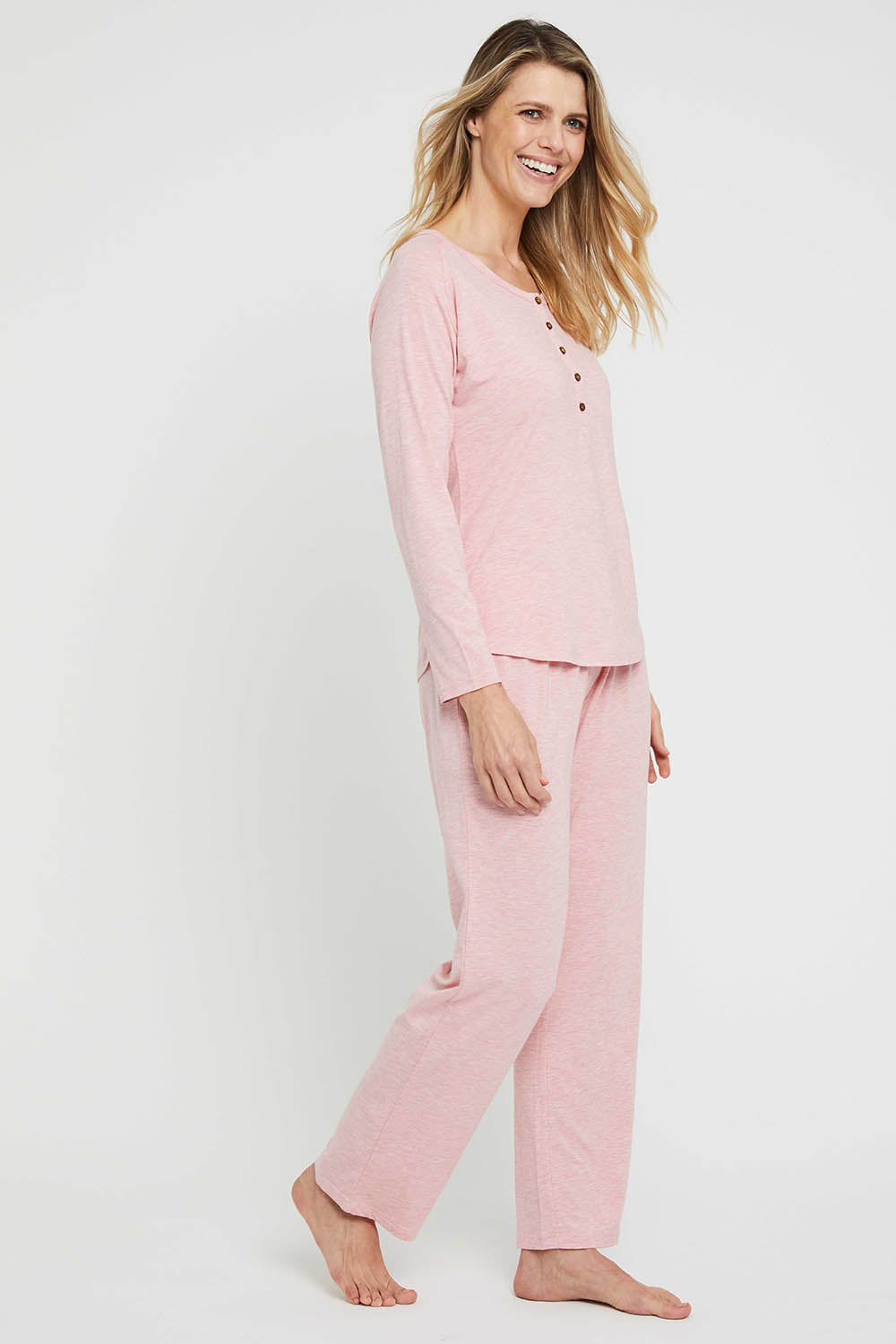A model wearing the Relax PJ Long Bamboo Pants in colour Rose (Pink), from the front, showing the whole outfit