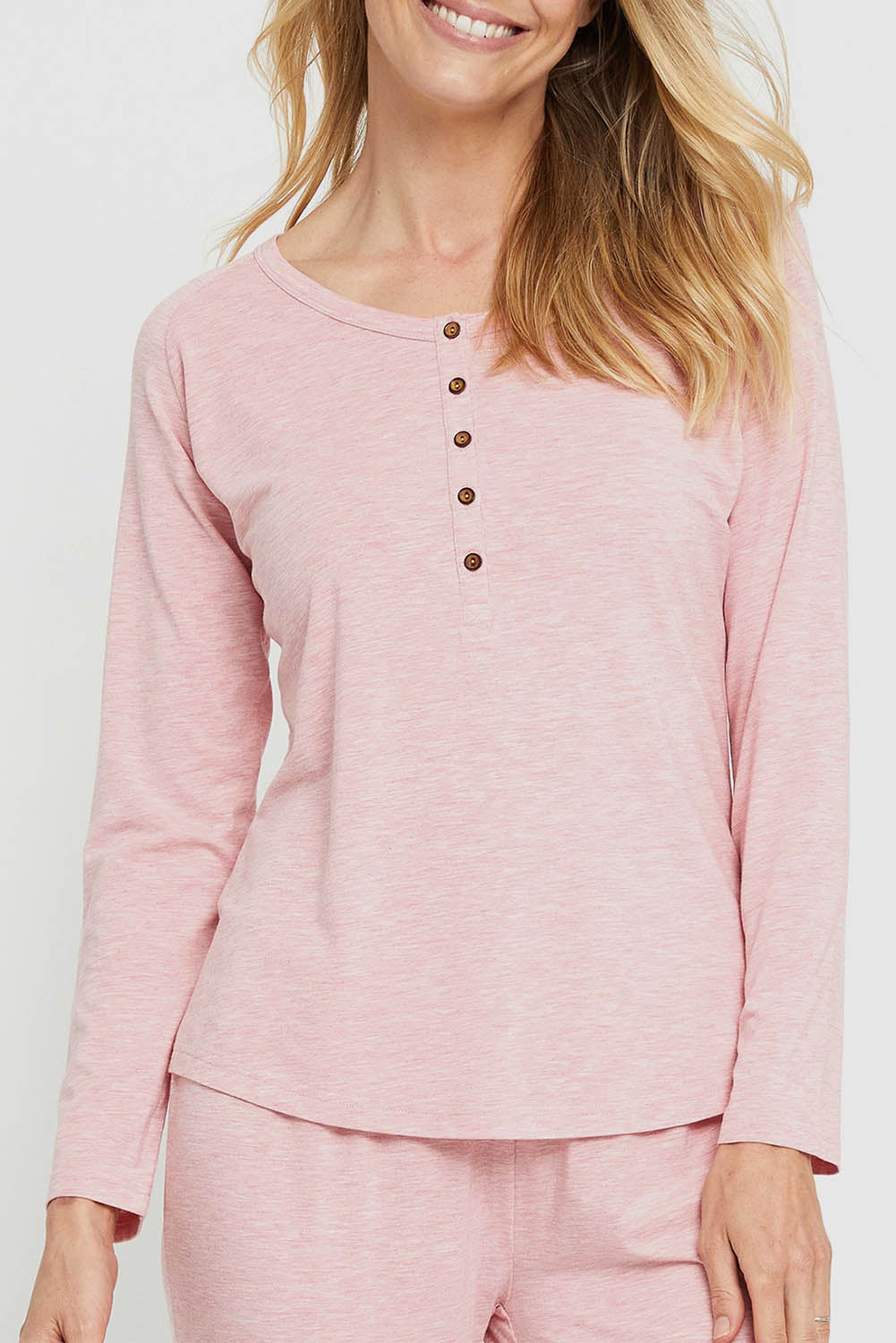 A model wearing the Henley Long Sleeve Bamboo Top in colour Rose (Pink), from the front, cropped image