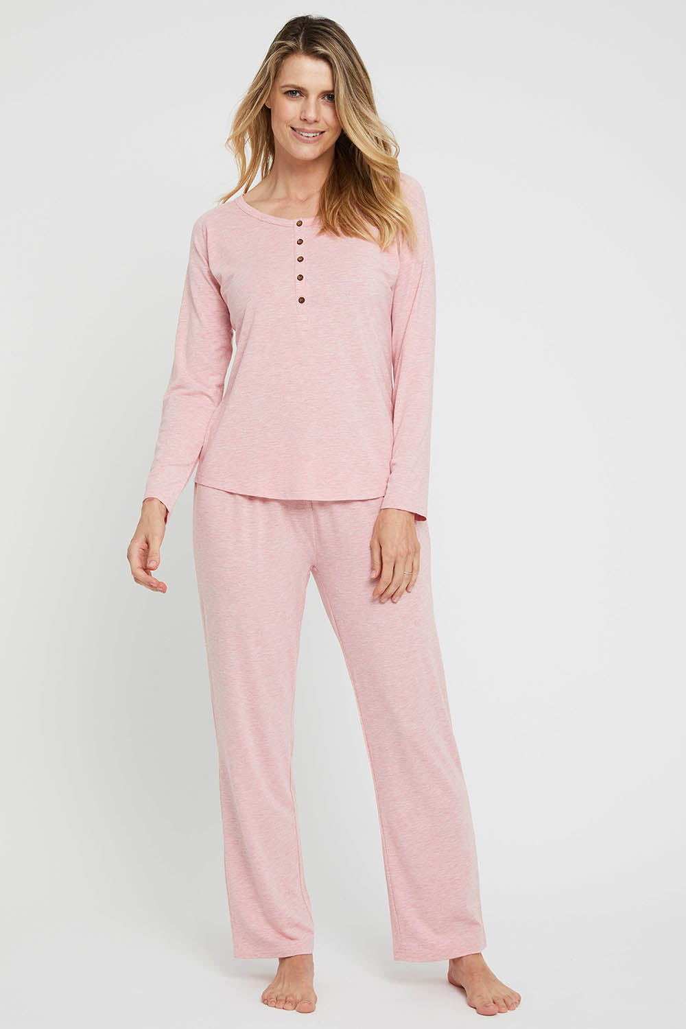 A model wearing the Henley Long Sleeve Bamboo Top in colour Rose (Pink), from the front, showing the whole outfit