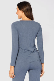 A model wearing the Henley Long Sleeve Bamboo Top in colour Twilight (Blue), from the back