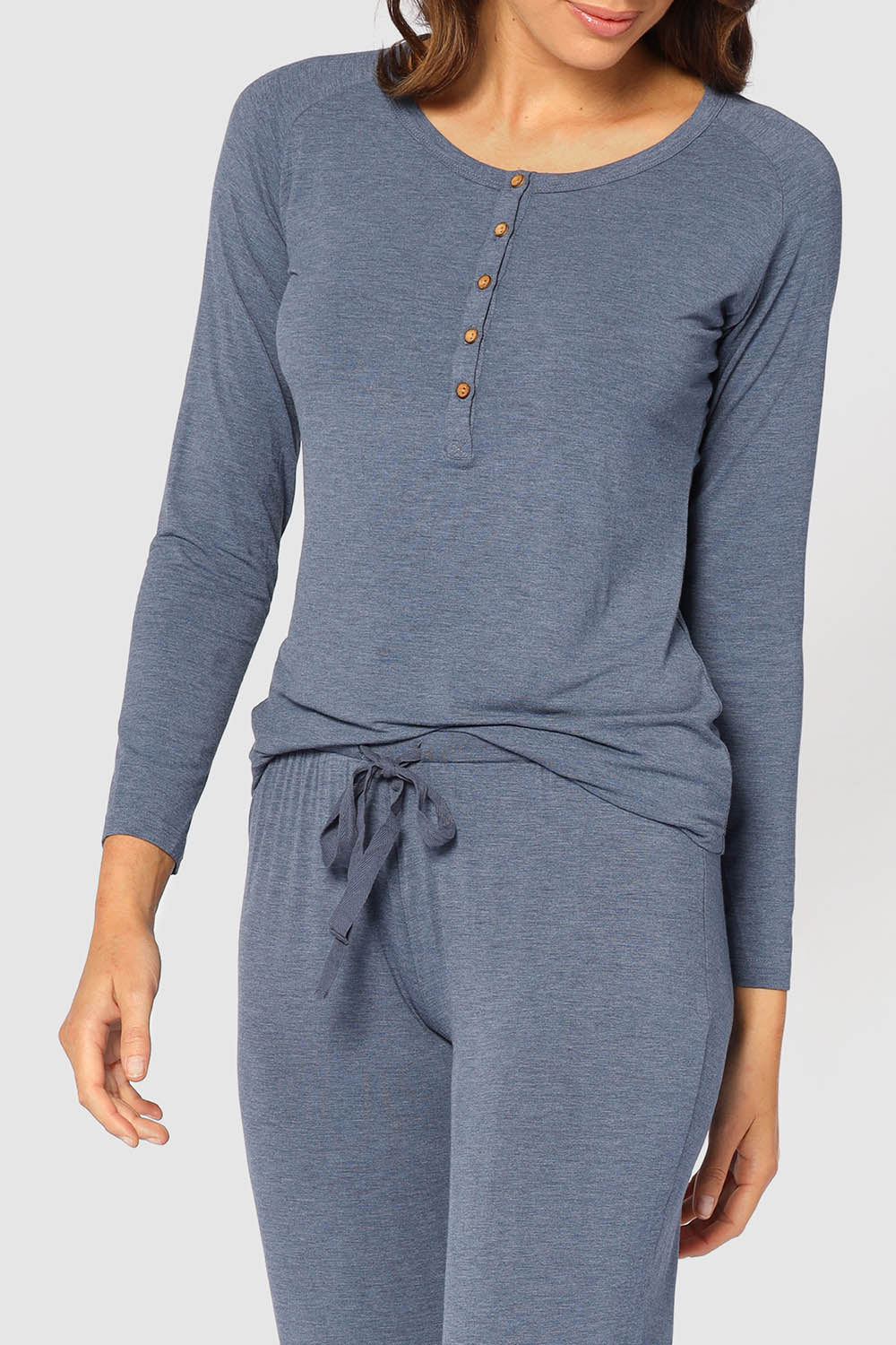 A model wearing the Henley Long Sleeve Bamboo Top in colour Twilight (Blue), from the front, cropped image
