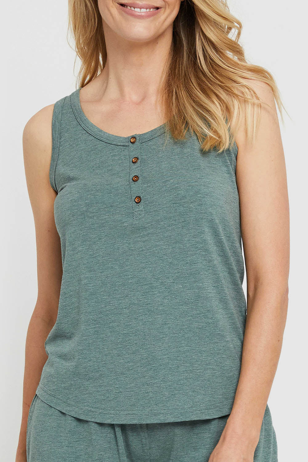 A model wearing the Henley Bamboo Singlet in colour Moss (Green), from the front, cropped image