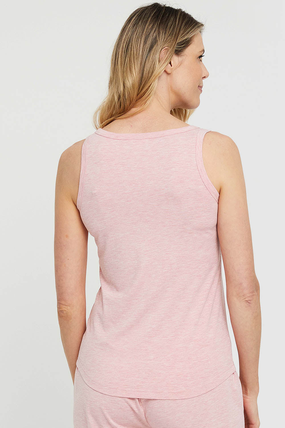 A model wearing the Henley Bamboo Singlet in colour Rose (Pink), from the back