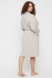 A model wearing the Bamboo Robe in colour Oatmeal, from the back