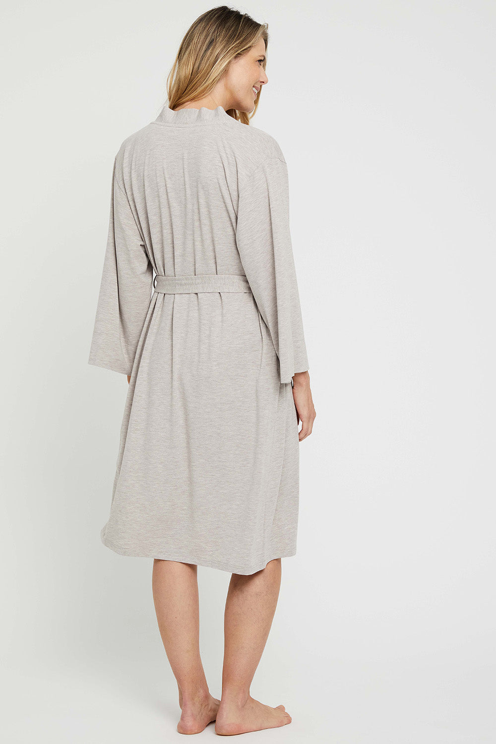 A model wearing the Bamboo Robe in colour Oatmeal, from the back