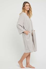A model wearing the Bamboo Robe in colour Oatmeal, from the front, showing the whole outfit