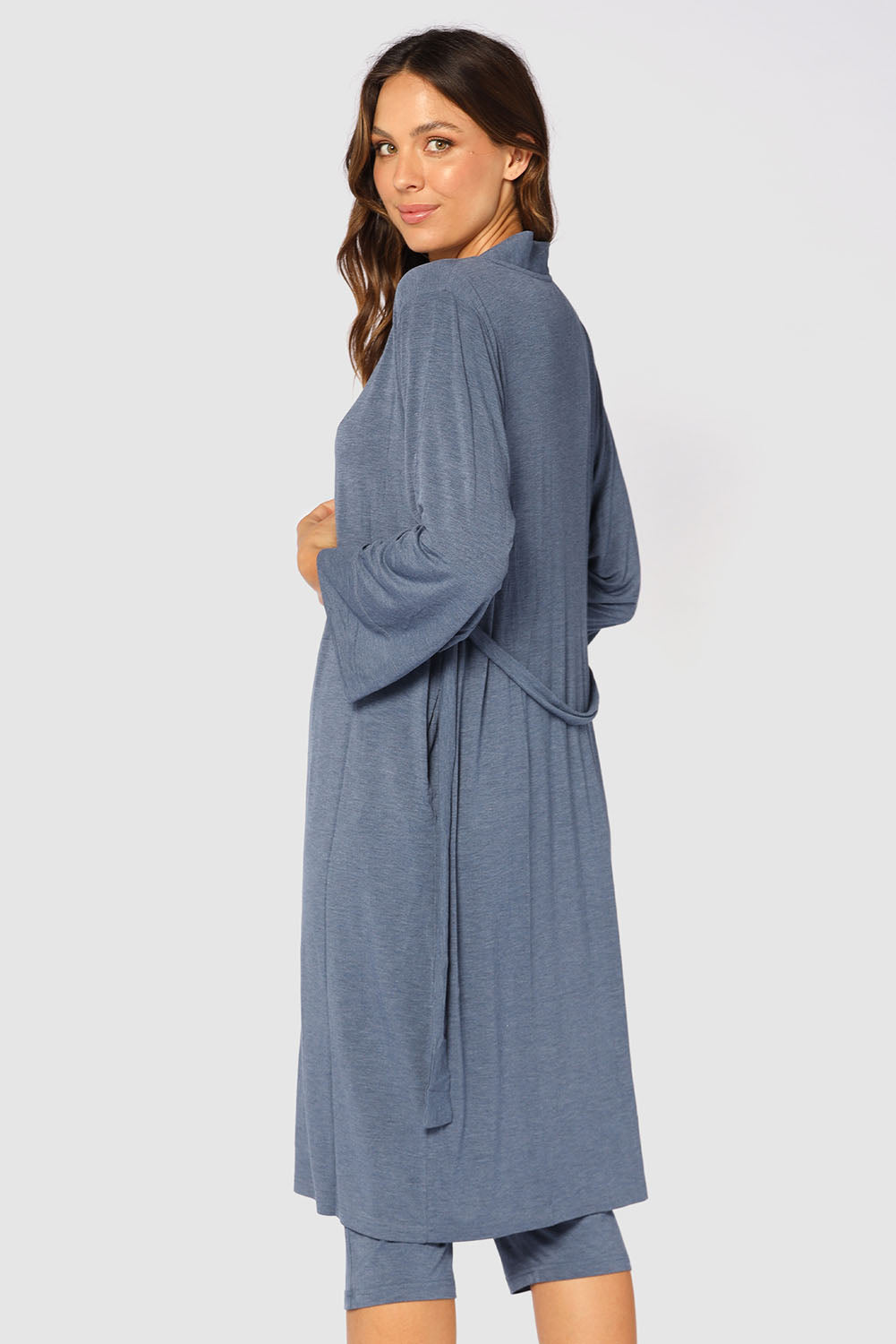 A model wearing the Bamboo Robe in colour Twilight (Blue), from the back