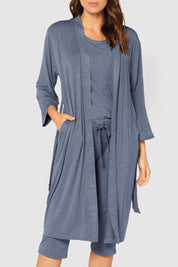 A model wearing the Bamboo Robe in colour Twilight (Blue), from the front, cropped image